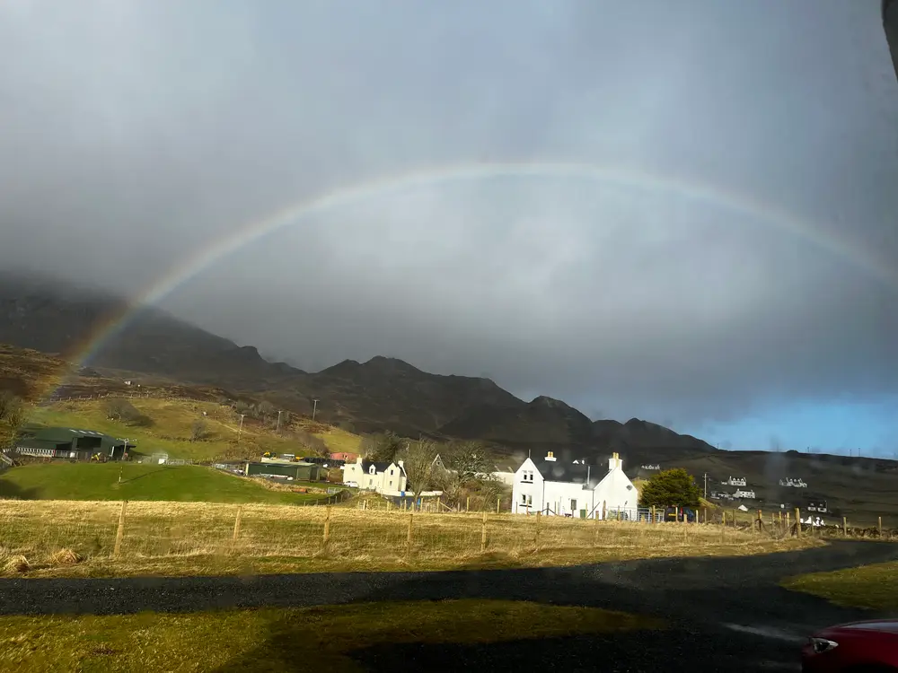A white house, a field and a rainbow 